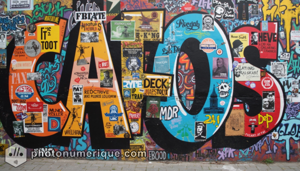 A collage-style mural combining various street art styles and messages.